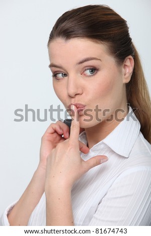 Stock photo: Portrait Of A Cheeky Businesswoman With Her Finger On Her Lips