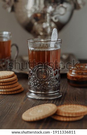 Foto stock: Hot Tea In Antique Cup Holder With Sugar Cookies On Old Brown Wooden Background Rustic Style