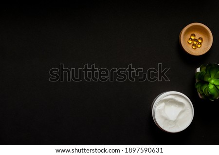 Сток-фото: Blank Black Cosmetics Bottles With White Small Flowers On Dark Wood Board Mock Up Top View Copy S