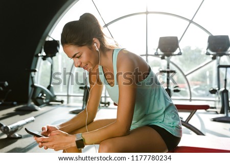 [[stock_photo]]: Portrait Of Fitness Sportsgirl In Tracksuit Listening To Music V