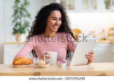Сток-фото: Pretty Curly Woman Sitting At The Kitchen Drinking Tea Eat Cake