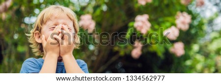 Foto stock: Boy Blowing Nose In Front Of Blooming Tree Spring Allergy Concept Childrens Allergies Vertical Fo