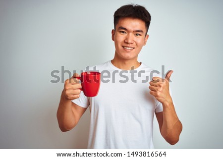 Stock fotó: A Young Man Drinks Chinese Tea On A Background Of Red Chinese Lanterns In Honor Of The Chinese New Y
