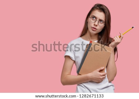 [[stock_photo]]: Young Brunette Businesswoman With Glasses Pen Thinking On Desk