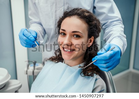 ストックフォト: Dentist Examining A Patients Teeth In The Dentists Chair With As