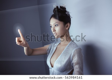 Foto stock: Future Concept Young Pretty Asian Woman Touching Digital Hologram