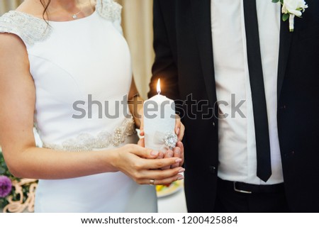 Stock foto: Candle In The Hands Of The Newlyweds Symbolizes Hearth And Well Being Of The Family