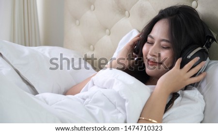 Stock fotó: Image Of Happy Asian Woman 30s Wearing Earphones Listening To Mu