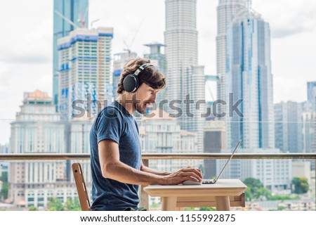 ストックフォト: Young Man Teaches A Foreign Language Or Learns A Foreign Language On The Internet On Her Balcony Aga