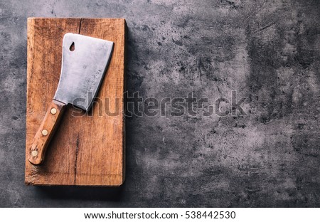Foto stock: Vintage Meat Knife And Fork On Vintage Chopping Board And Black Stone Table Background Butcher Uten