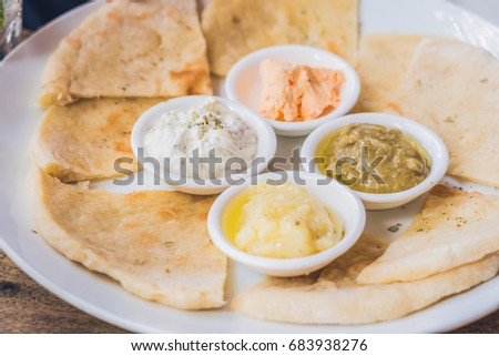 Zdjęcia stock: Pieces Of Pita Bread And Four Kinds Of Greek Sauces Greek Food Concept