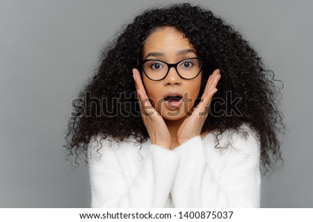 Stock fotó: Omg It Cannot Be So Surprised Emotional Dark Skinned Young Female With Curly Hair Touches Both Ch