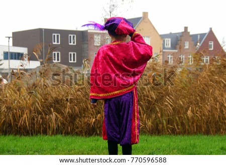 Foto stock: Zwarte Piet Black Pete Typical Dutch Character With Young Chi