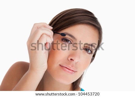Foto stock: Attractive Teenager Leaning Her Head While Applying Eyeshadow On Her Eyelid