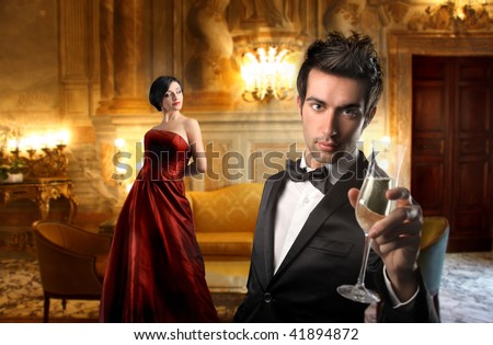 [[stock_photo]]: Portrait Of Elegant Young Couple With Champagne Flutes In Limous