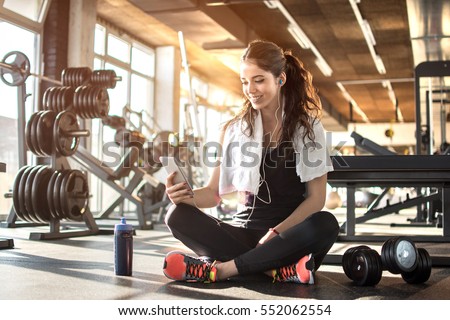 Stockfoto: Young Fit Sporty Woman Resting And Listen Music On Mobile Phone