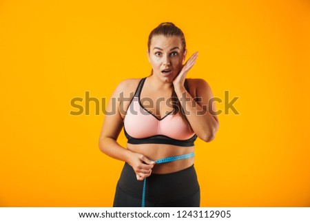 ストックフォト: Portrait Of Excited Chubby Woman In Sportive Bra Measuring Her W
