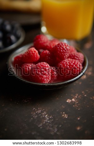 ストックフォト: Close Up On Fresh Raspberries Placed On Ceramic Saucer On Dark Rusty Table