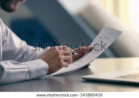 Stock foto: Male Lawyer Working With Contract Papers And Reading Law Book In