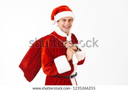 Zdjęcia stock: Portrait Of Optimistic Man 30s In Santa Claus Costume And Red Ha
