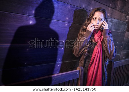 Foto stock: Frightened Young Adult Woman Walking As Mysterious Male Shadow F