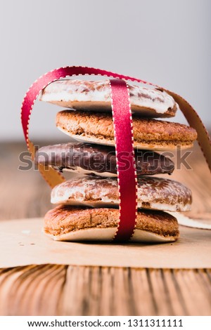 Stockfoto: A Few Gingerbread Cookies Wrapped In Red Ribbon Happy Christmas