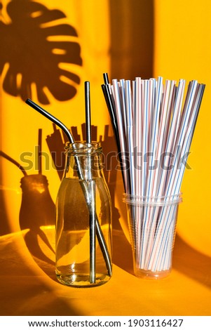 Foto d'archivio: Steel Drinking Vs Disposable Straws On A Yellow Background Zero Waste Concept