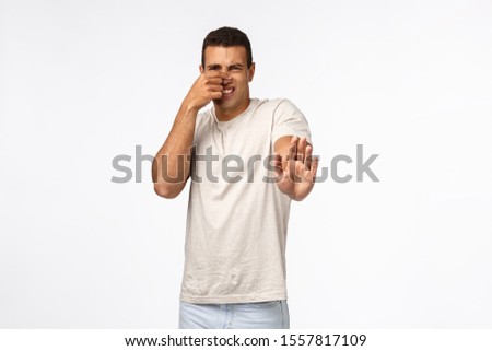 Foto stock: Guy Feel Disgusted From Awful Bad Smell Rejecting Stinky Cheese Plate Close Nose With Fingers Sha