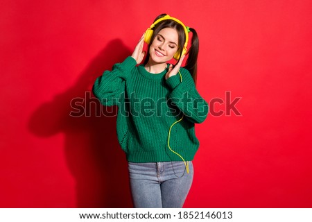 Zdjęcia stock: Charming Young Woman With Ponytail Listening To Good Music While Lying On Comfortable Bed