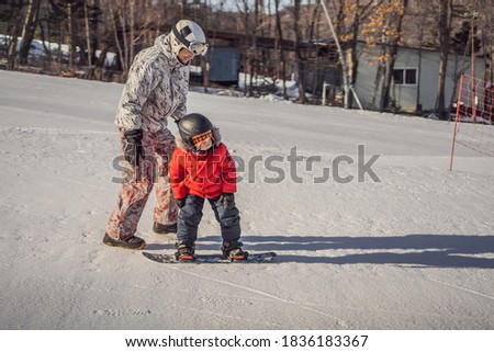 Stock photo: Dad Teaches Son Snowboarding Activities For Children In Winter Childrens Winter Sport Lifestyle