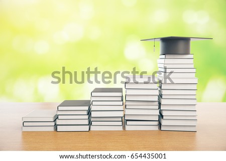 Foto stock: Graduation Mortarboard On Top Of Stack Of Books On Wooden Backgr