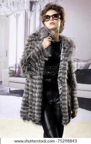 [[stock_photo]]: Fashionable Woman Wearing Fur Coat In Studio In Front Of Christm