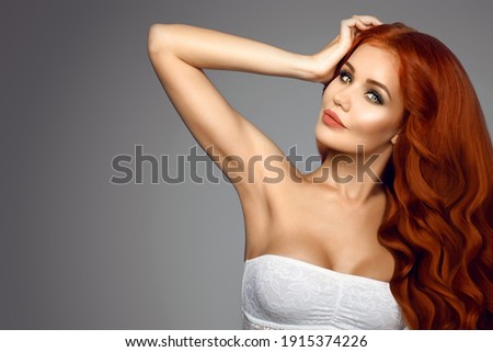 Stock photo: The Girl Raises Her Long Curly Hair The Girl With Well Groomed Curly Hair Curly Long Brown Hair S