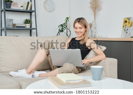 Stockfoto: Young Blonde Woman Sitting On The Bed In The Room Looks Melancho