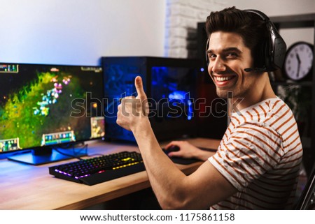 Сток-фото: Portrait Of Joyful Gamer Guy In Headphones Playing Video Games O