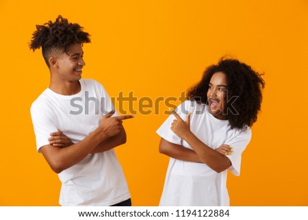 Zdjęcia stock: Happy Young Cute Loving Couple Posing Isolated Over Yellow Background