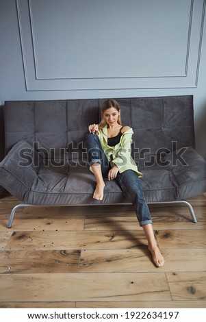 Stok fotoğraf: Beautiful Young Woman In Bra And Shirt Sitting On Bed And Having Good Breakfast