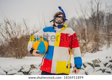 Stock photo: The Man Went Outside In Winter In Snorkeling Equipment And With A Beach Ball A Man Dreams Of A Vaca