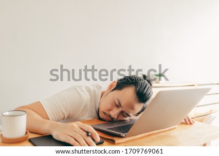 Foto d'archivio: Handsome Asian Freelancer Working On His Laptop Computer Remotel
