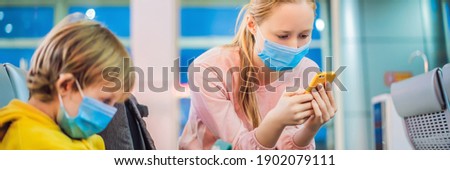 Foto stock: Family At Airport Before Flight Mother And Son In Medical Mask Waiting To Board At Departure Gate O