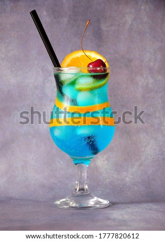 Zdjęcia stock: Blue Lagoon Cocktail Classic Glass With Straw And Orange Slice On White Sweet Cherries On Cocktail