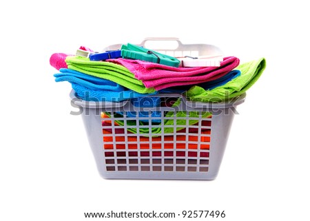 Stockfoto: Laundry Basket Filled With Colorful Folded Towels Pegs And Bott