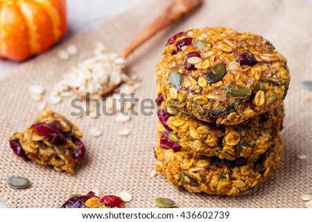 Foto stock: Pumpkin Oat Cookies With Cranberries Maple Glaze And Glass Of Milk On A Blue Textile Background