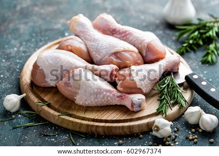 Foto stock: Raw Uncooked Chicken Legs Drumsticks On Wooden Board Meat With Ingredients For Cooking Top View