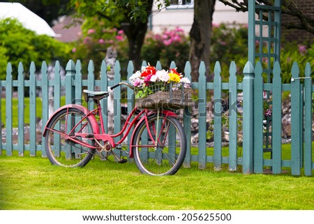 Stockfoto: Beautiful Bicycle With Flowers In A Basket Stands On The Street