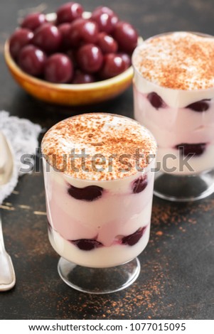 Stock fotó: The Glasses With Dairy Product Pink Yogurt Standing On A Black Wooden Table On A Black Natural Orga