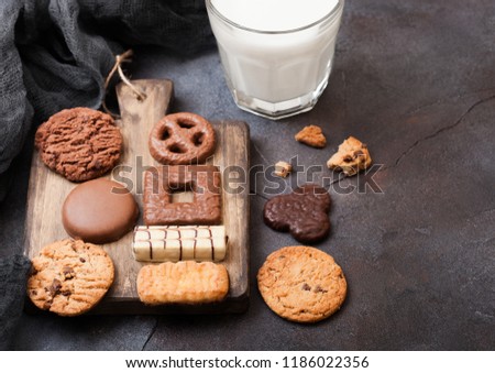 Oat And Chocolate Cookies Selection With Glass Of Milk On Wooden Board On Stone Kitchen Table Backgr Foto stock © DenisMArt