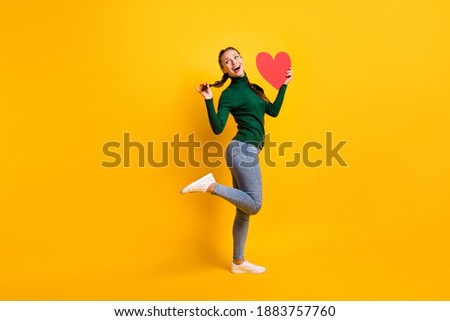 Сток-фото: Girl With Red Pigtails On A Yellow Background A Charming Girl In Round Transparent Glasses Is Holdi