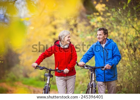 Stock fotó: Active Senior Couple Together Enjoying Romantic Walk With Bicycl