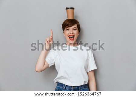 Stockfoto: Woman Standing Over Grey Wall Background Drinking Coffee Wearing Glasses